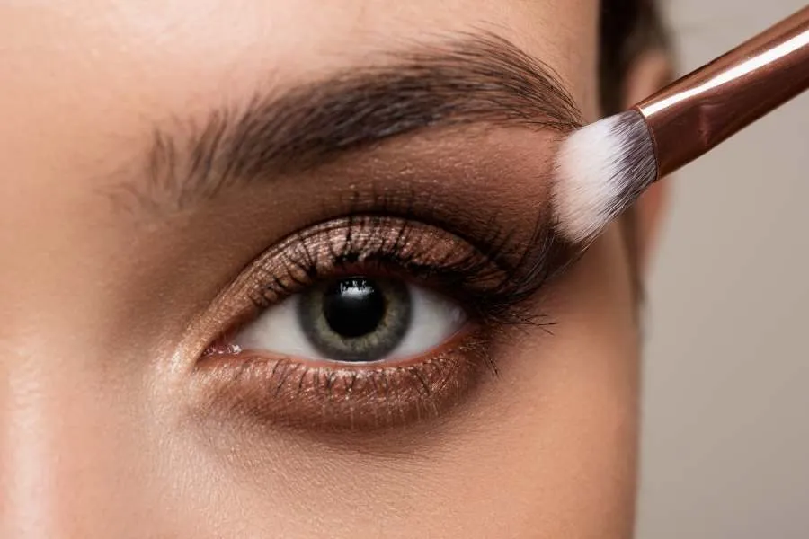 woman applying eye makeup
